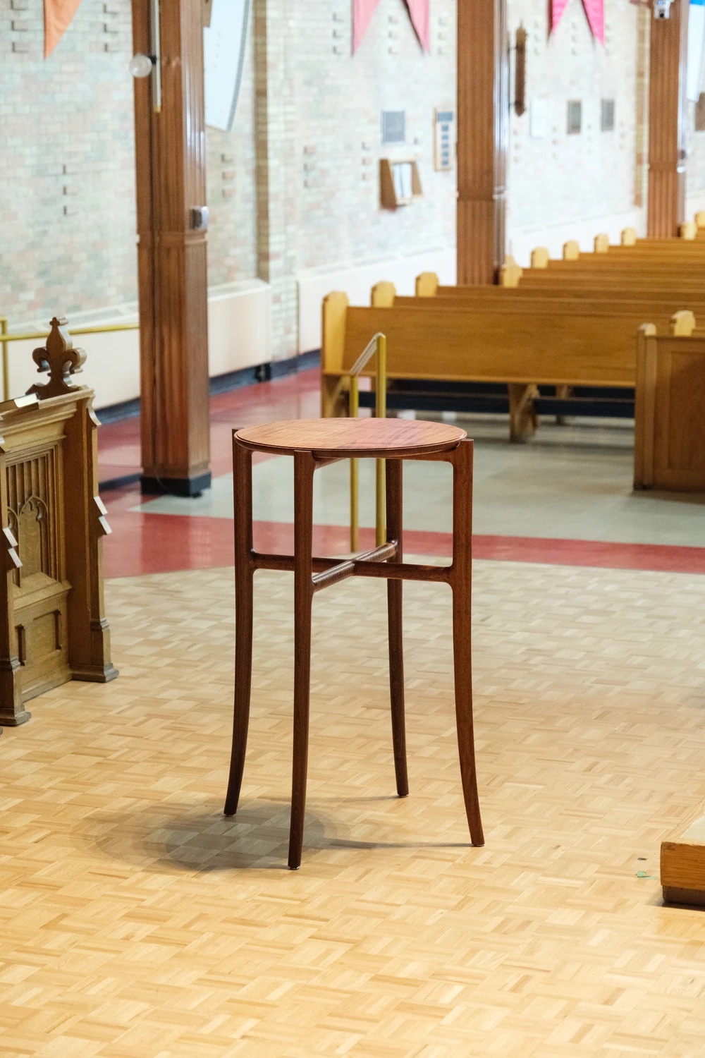 A finished wooden stand in a church interior.