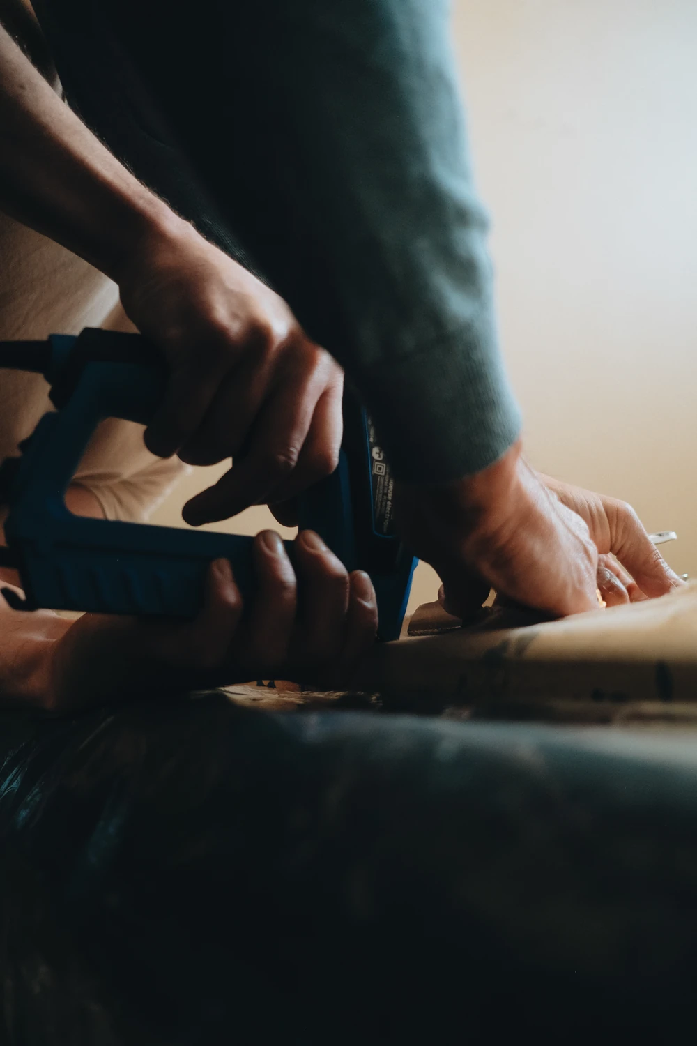 A close view of hands and a tool during installation work.