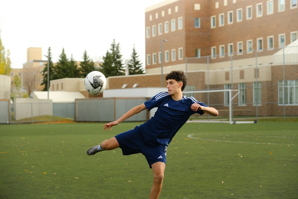 A football player and ball caught in an athletic movement.