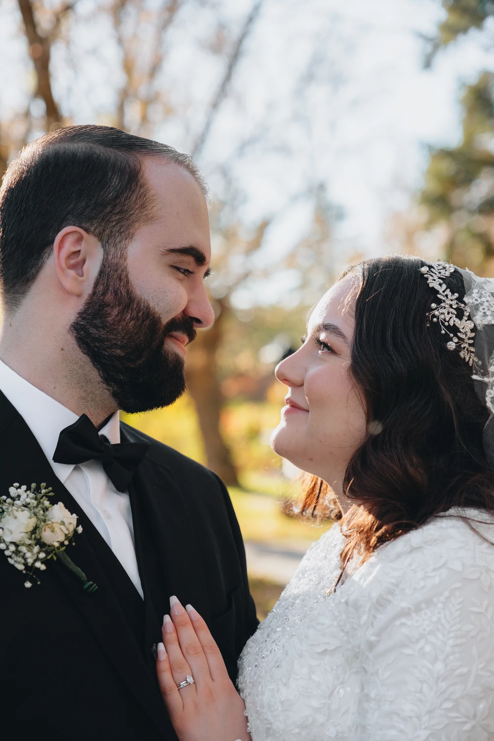 A close wedding portrait of a couple looking into each other’s eyes.