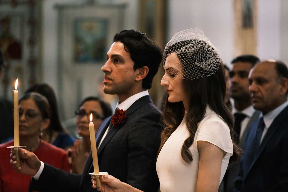 A wedding couple holding candles during their ceremony.