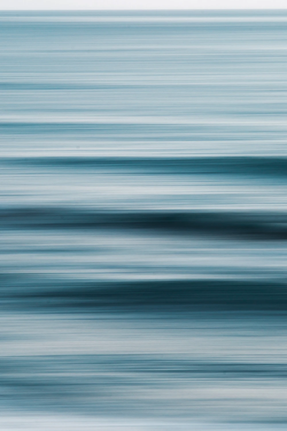 An abstract water photograph rendered as horizontal bands of pale and deep blue.
