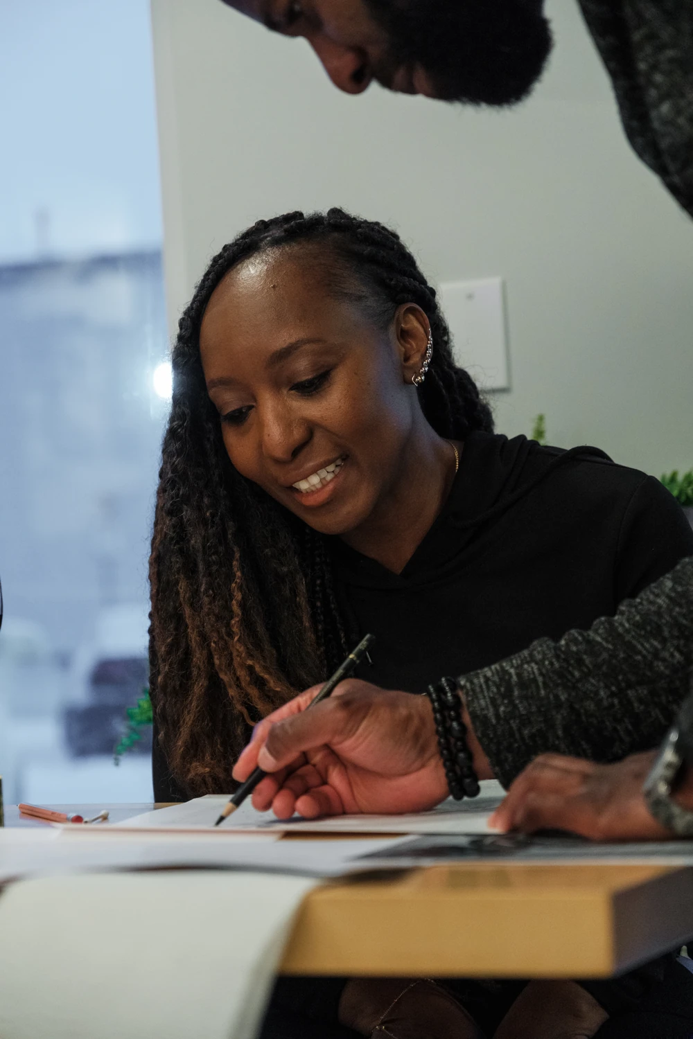 A smiling participant following an instructor’s drawing demonstration at Art with Ola.